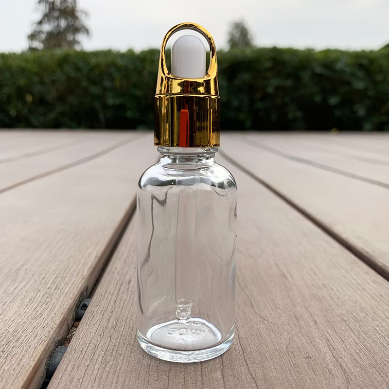 Flacon compte-gouttes en verre transparent avec bouchon doré